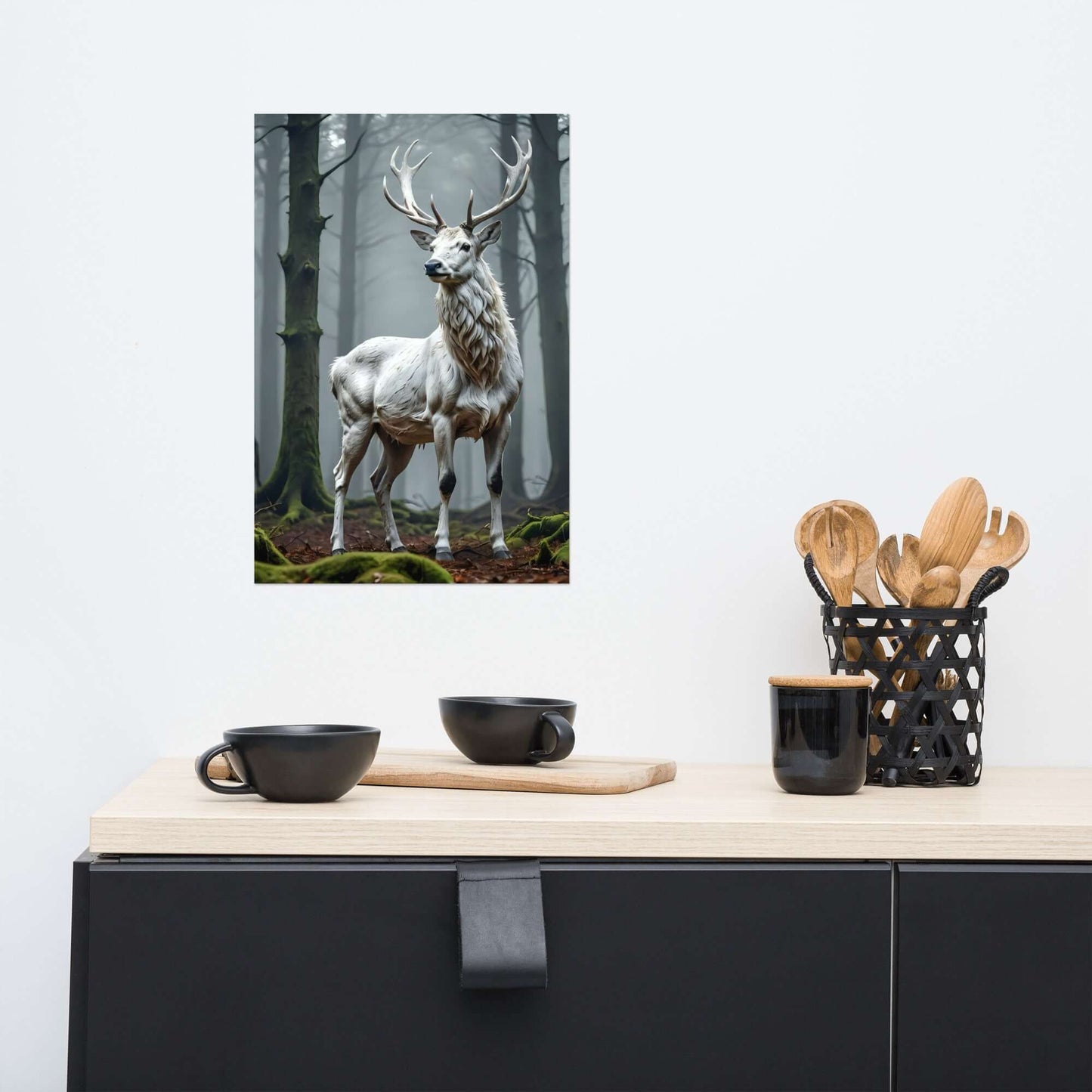 Framed artwork of a deer in a forest on a wall above a kitchen counter with utensils.