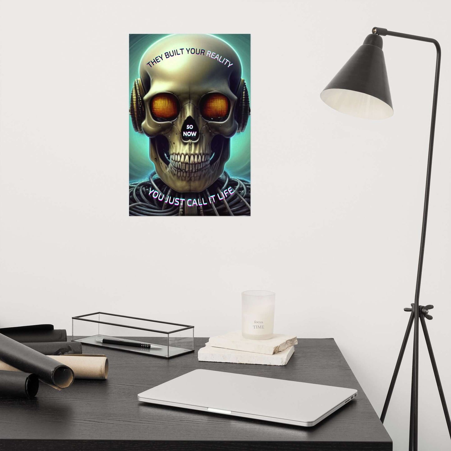 Skull-themed poster on a wall above a desk with a laptop and lamp.