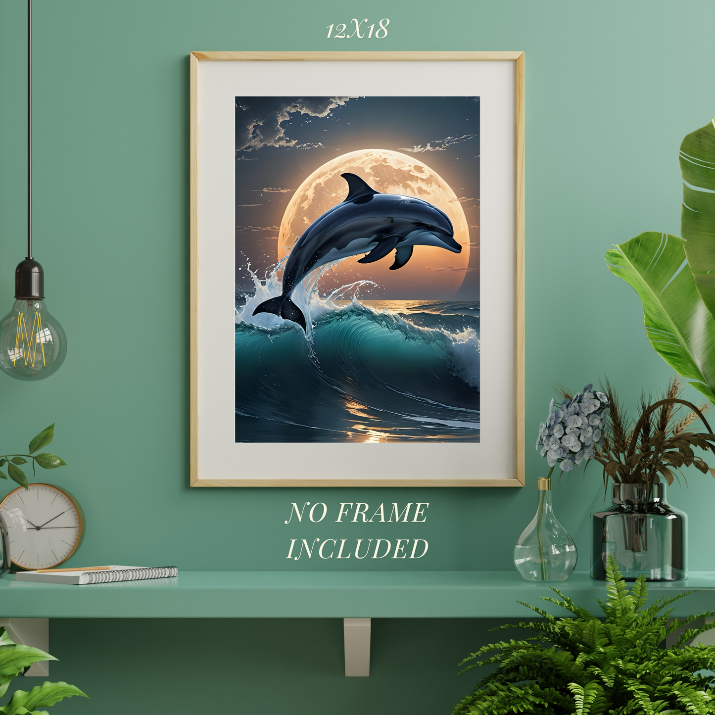 Framed artwork of a dolphin leaping over waves with a moon in the background, on a green wall.