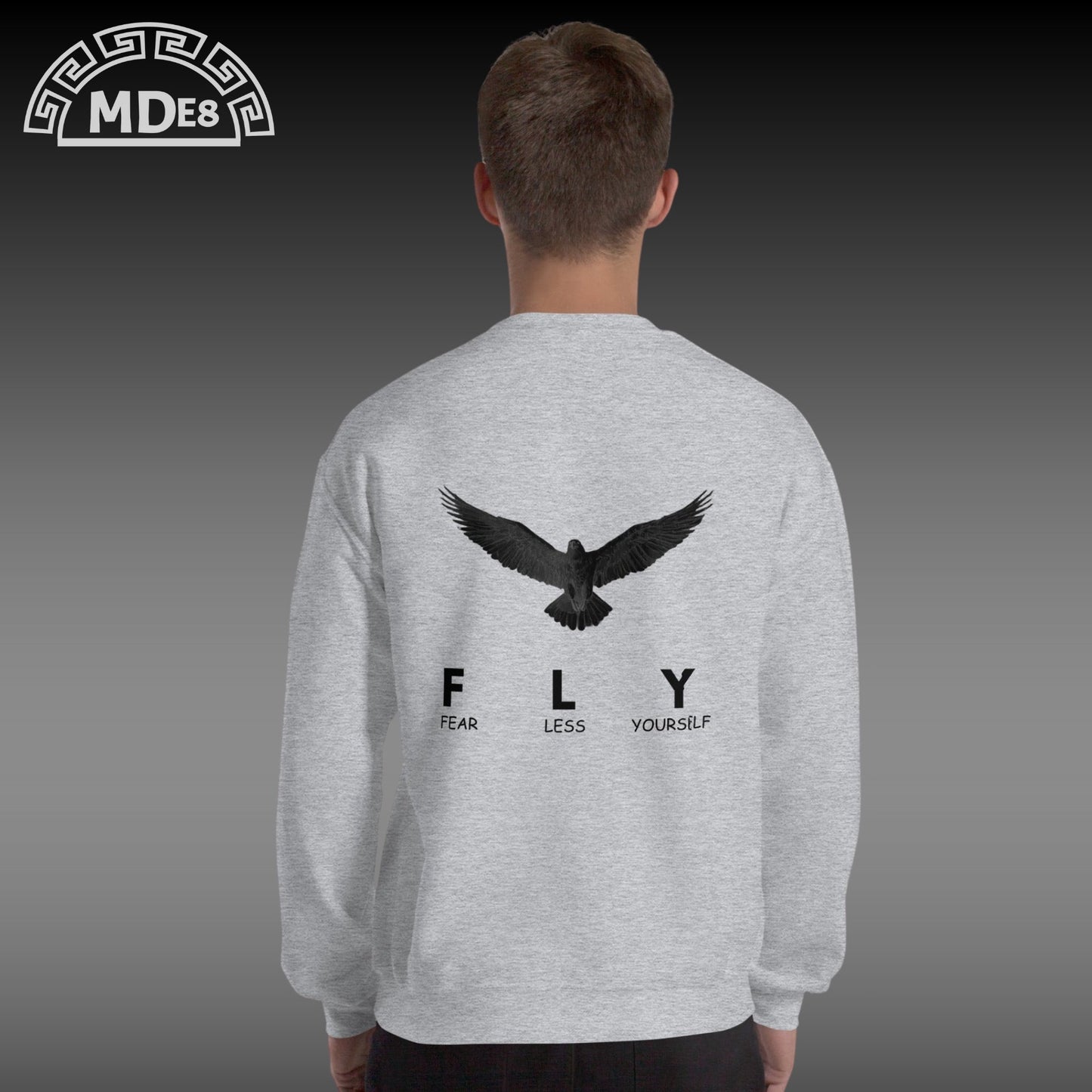 Gray sweatshirt with an eagle design and text on the back, worn by a person.